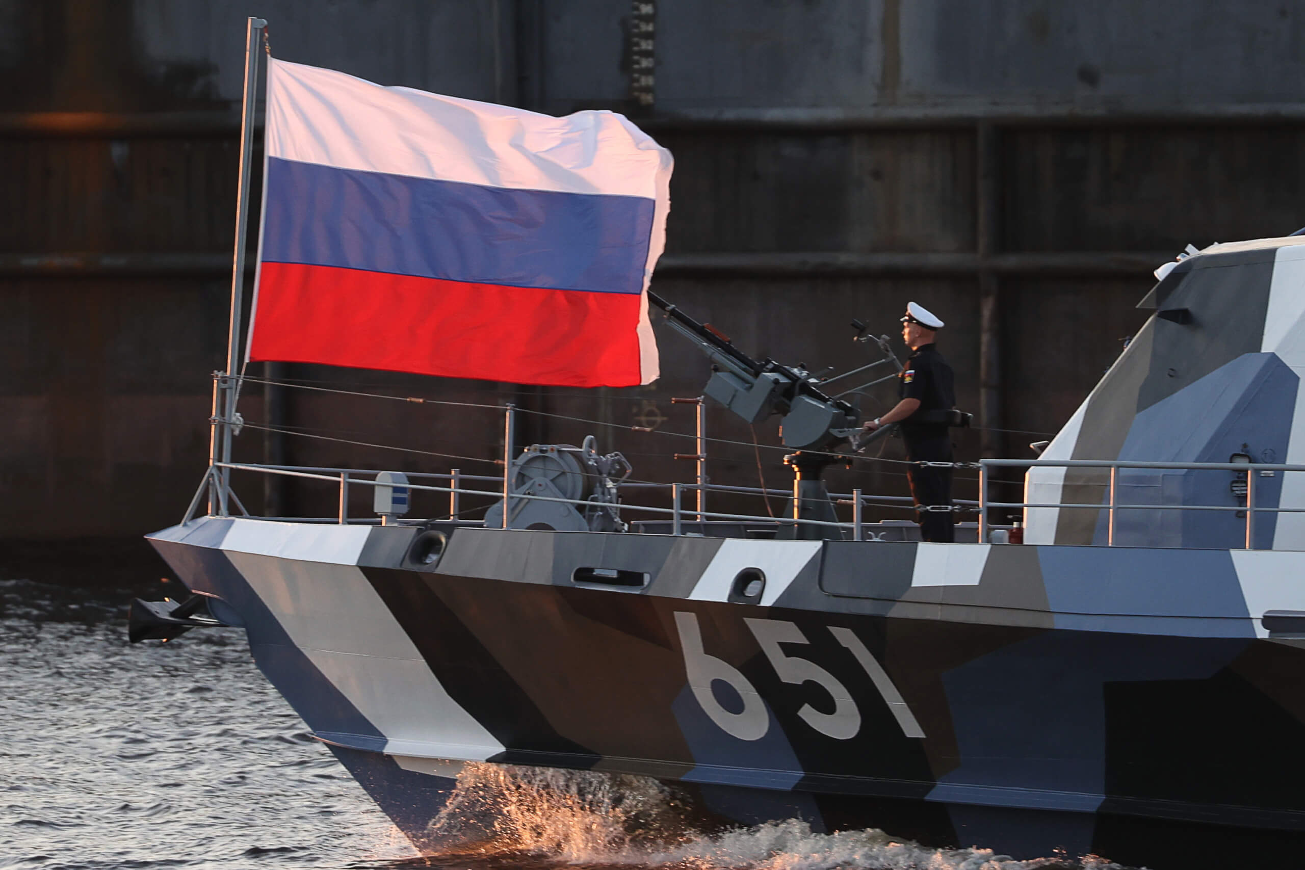 Russische Fahne und ein Seemann auf einem russischen Kriegsschiff.