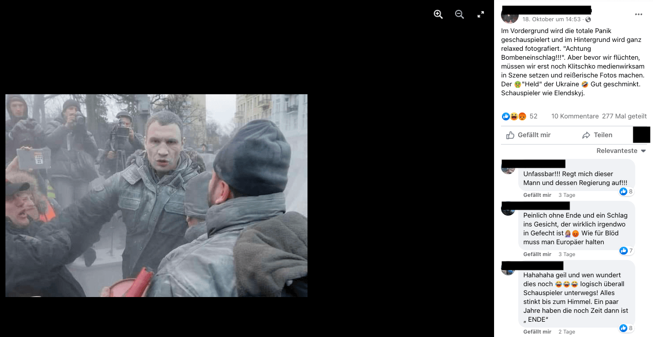 Ein Foto von Vitali Klitschko, der mit grauem Staub bedeckt ist, und Fotografen