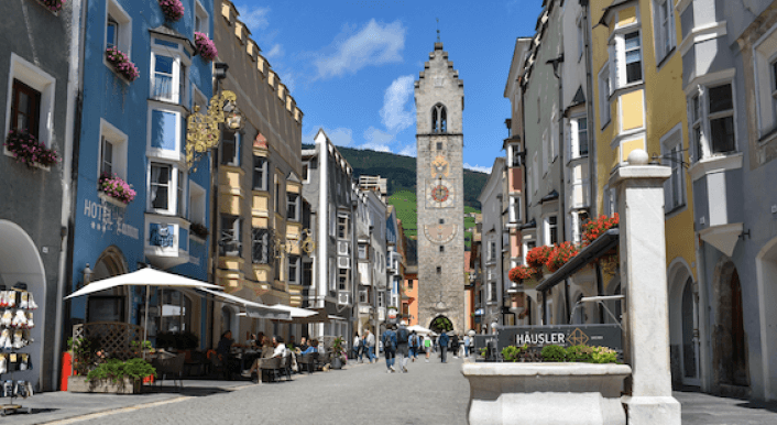 Ein Foto einer Altstadt, am Ende einer Straße steht ein Turm.