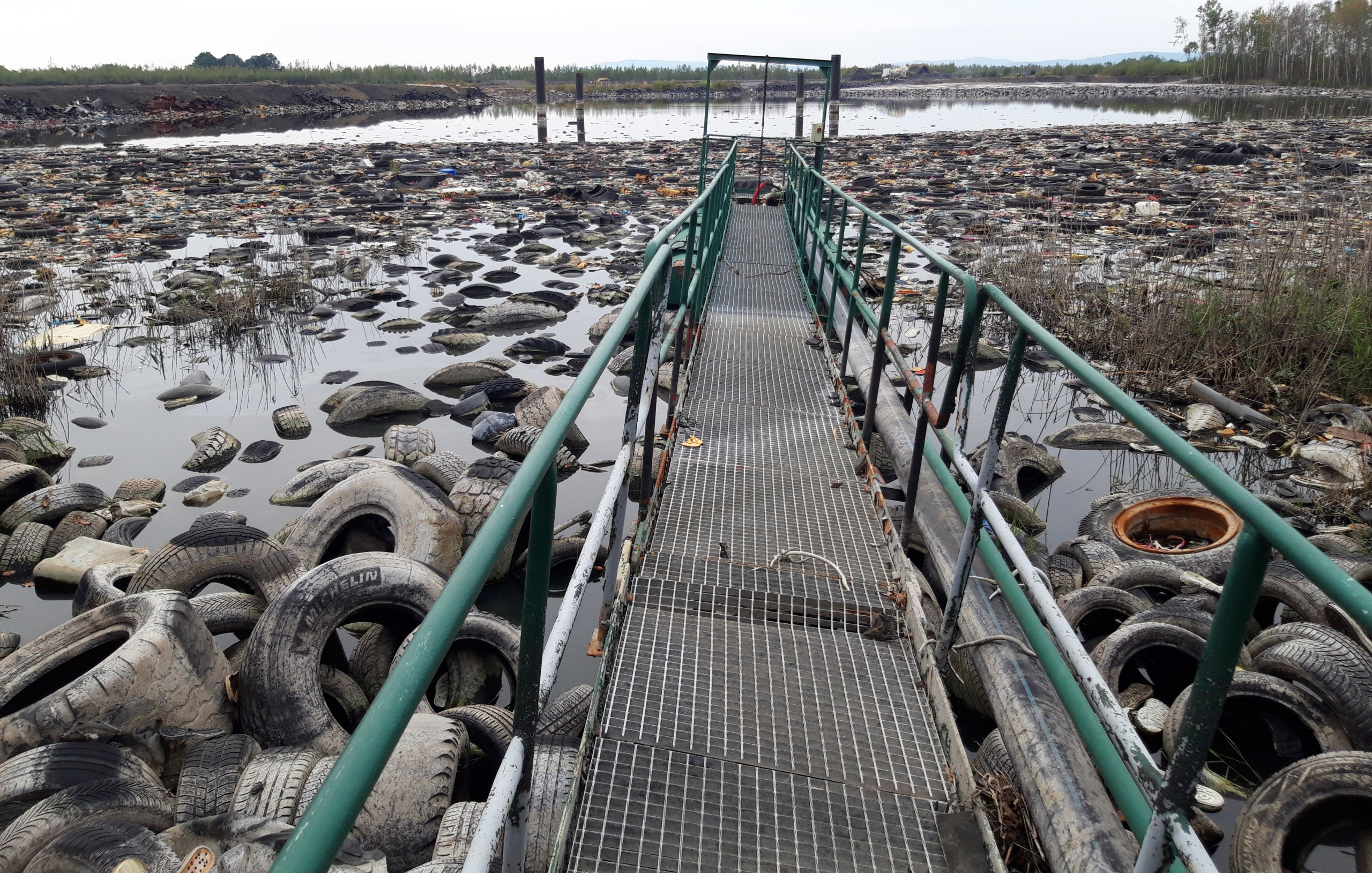 Mydlovary rubber waste and tyres A water surface, covered with floating car tyres and other rubber waste