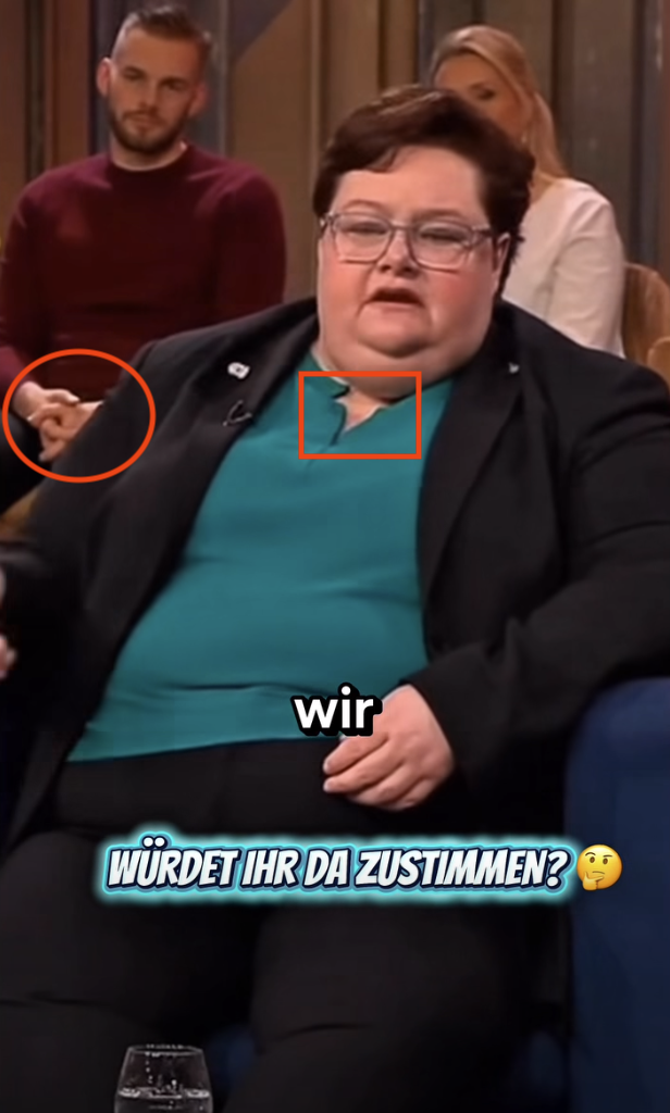 Die Kleidung der Frau ist asymmetrisch und die Hände des Zuschauers haben seltsame Proportionen