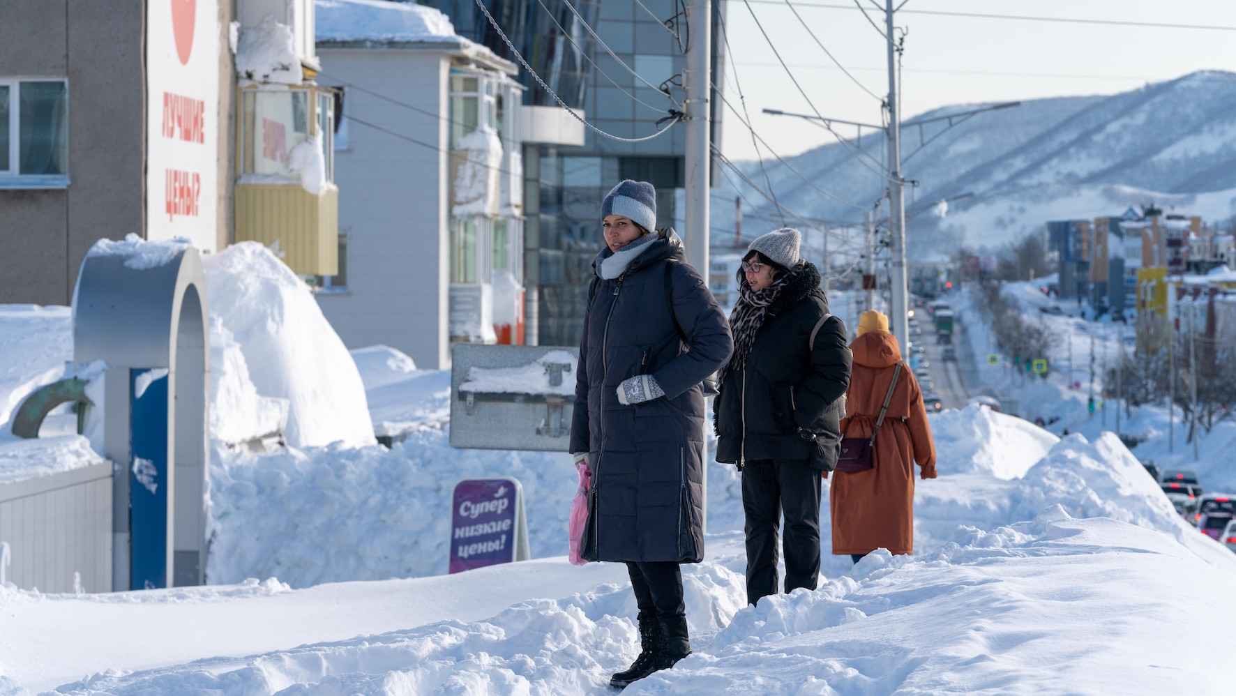 Menschen stehen an einer Straße auf Schneebergen in Kamtschatka