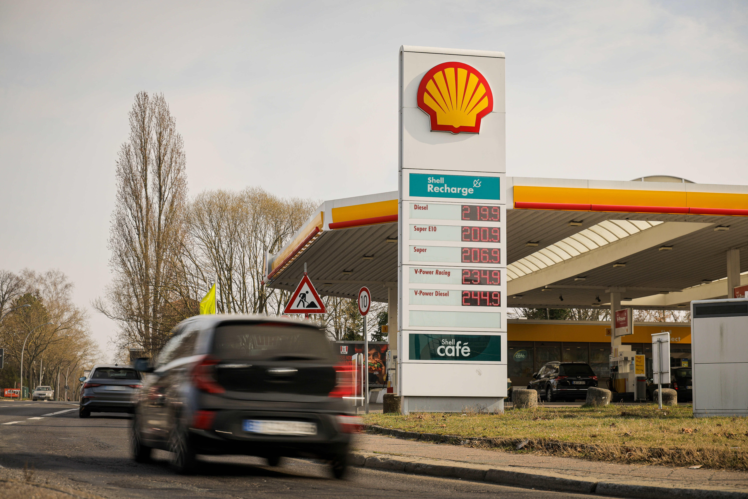 Eine Tankstelle und ein vorbeifahrendes Auto