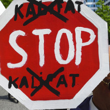 Ein Schild auf einer Demo, auf dem „Stop Kalifat“ steht