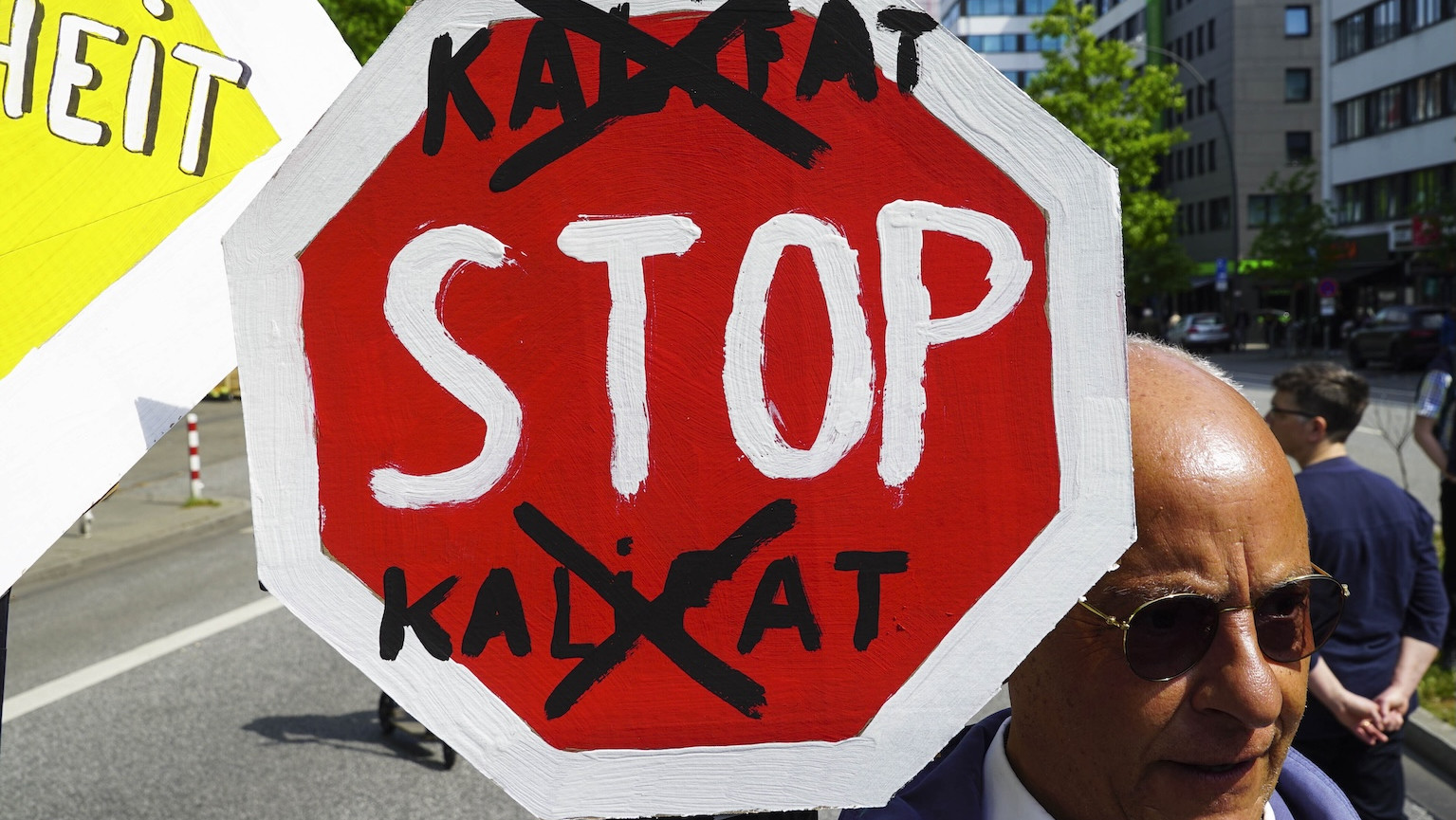 Ein Schild auf einer Demo, auf dem „Stop Kalifat“ steht